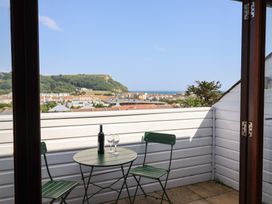 A balcony with a table and chairs at Cliff View in Seaton