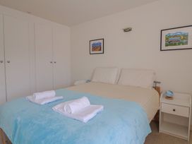 A bedroom with a bed and bedside table at Cliff View in Seaton