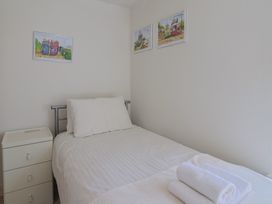 A bedroom with a bed and wall art at Cliff View in Seaton