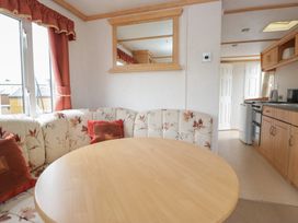 A dining room with a table and seating at Holly in Denny