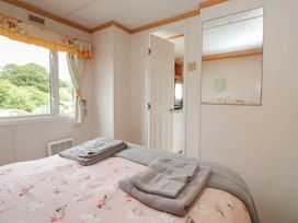 A bedroom with a bed and towels on top at Holly in Denny