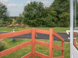 A view of a garden and pathway from a fence at Holly in Denny