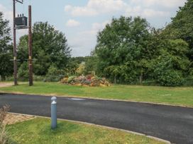 An outdoor view with flowers and trees near the road at Holly in Denny