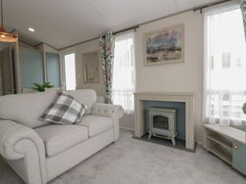 A living room with a sofa and fireplace at Yew in Denny
