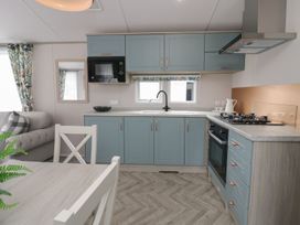 A kitchen with cabinets and appliances at Yew in Denny