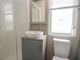 A bathroom with a sink and toilet at Yew in Denny