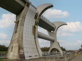 A bridge structure with supports and a walkway at Yew in Denny