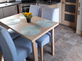 A kitchen with a table and chairs at Yew in Denny