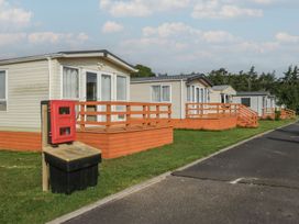 Caravans with porches and a mailbox at Ash in Denny