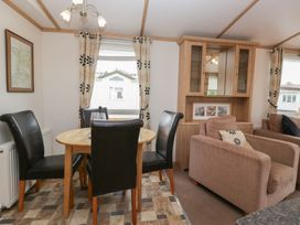 A dining room with a table and chairs at Willow in Denny