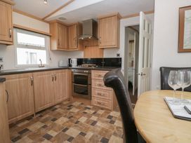 A kitchen with cabinets and appliances at Willow in Denny