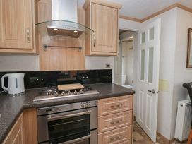 A kitchen with a stove, oven, and kettle at Willow in Denny