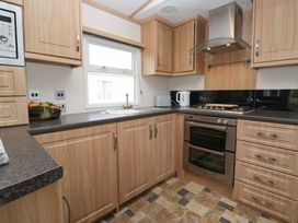 A kitchen with cabinets and appliances at Willow in Denny