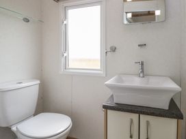 A bathroom with a sink and toilet at Willow in Denny