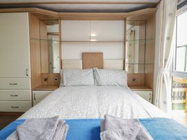 A bedroom with a bed and a wardrobe at Willow in Denny