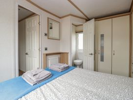 A bedroom with a bed and towels on a counter at Willow in Denny