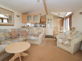 A living room with sofa and dining table at Birch in Denny