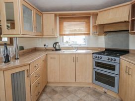 A kitchen with stove and sink at Birch in Denny