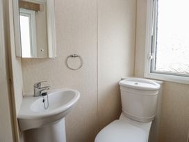 A bathroom with a sink and toilet at Birch in Denny