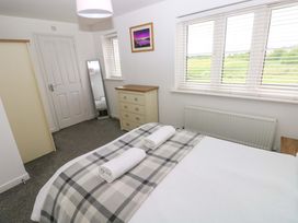 A bedroom with a bed and a dresser at 69 Ffordd Y Meillion in Llanelli
