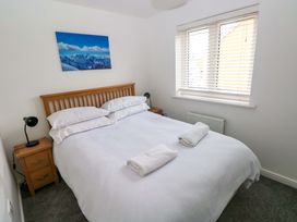 A bedroom with a bed and nightstand at 69 Ffordd Y Meillion in Llanelli