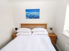 A bedroom with a bed and bedside tables at 69 Ffordd Y Meillion in Llanelli