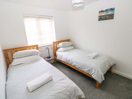 A bedroom with two single beds and a window at 69 Ffordd Y Meillion in Llanelli