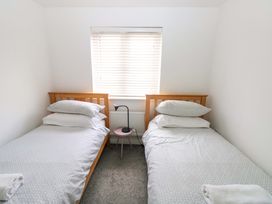 A bedroom with two single beds and a window at 69 Ffordd Y Meillion in Llanelli