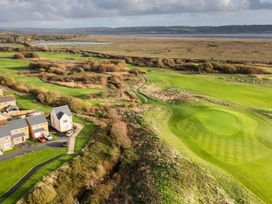 An aerial view of a golf course and residential area at 69 Ffordd Y Meillion Llanelli