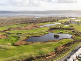 A golf course with water bodies and houses at 69 Ffordd Y Meillion, Llanelli