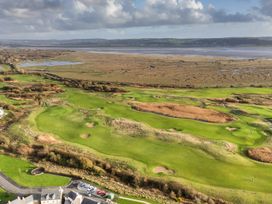 An aerial view of a golf course with ponds and houses at 69 Ffordd Y Meillion in Llanelli