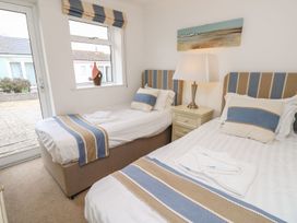 A bedroom with two single beds a nightstand and a lamp at Forbes C1 in Yarmouth