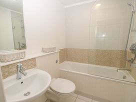 A bathroom with a sink toilet bathtub and shower at Forbes C1 in Yarmouth