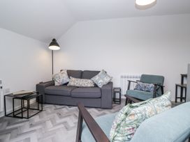 A living room with a sofa and armchair at Claife Flights in Bowness-On-Windermere