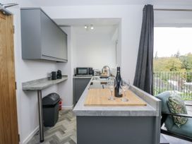A kitchen with a sink and bar area at Claife Flights in Bowness-On-Windermere