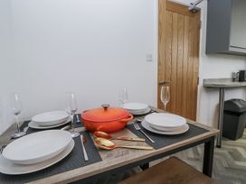 A dining room table set with plates, cutlery, and a soup pot at Claife Flights Bowness-On-Windermere
