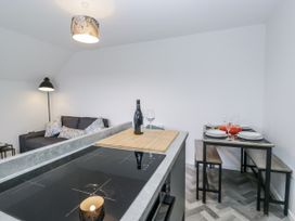 A kitchen with a dining table and seating at Claife Flights in Bowness-On-Windermere