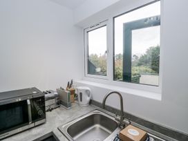 A kitchen with a sink and appliances at Claife Flights in Bowness-On-Windermere