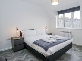 A bedroom with a bed and bedside table at Claife Flights in Bowness-On-Windermere