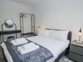 A bedroom with a bed and a clothes rack at Claife Flights in Bowness-On-Windermere