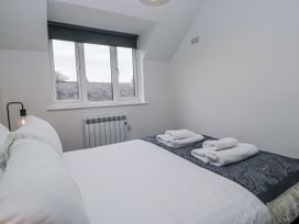 A bedroom with a bed and towels on top at Claife Flights Bowness-On-Windermere