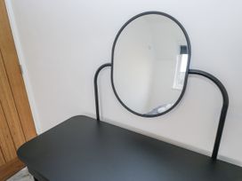 A dressing table with a mirror in a bedroom at Claife Flights Bowness-On-Windermere