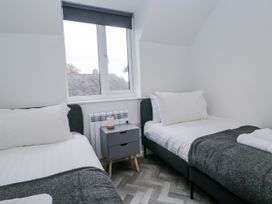 A bedroom with two beds and a window at Claife Flights in Bowness-On-Windermere