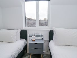 A bedroom with two beds and a window at Claife Flights Bowness-On-Windermere