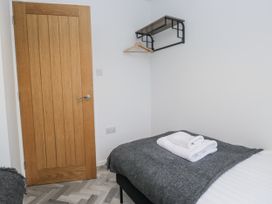 A bedroom with a bed and towels at Claife Flights in Bowness-On-Windermere