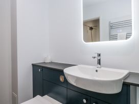 A bathroom with a sink and mirror at Claife Flights in Bowness-On-Windermere