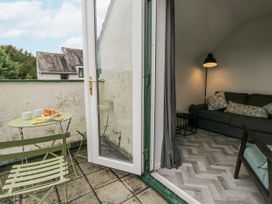 A balcony with a green table and chairs at Claife Flights in Bowness-On-Windermere