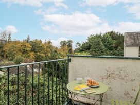 A table with croissants and mugs on a balcony at Claife Flights in Bowness-On-Windermere