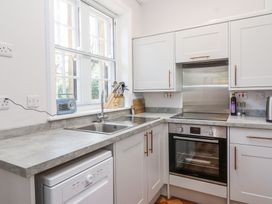 A kitchen with a sink, oven, and countertop appliances at Middle Lodge near Taunton