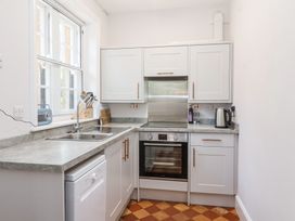 A kitchen with a sink stove oven kettle and window at Middle Lodge near Taunton
